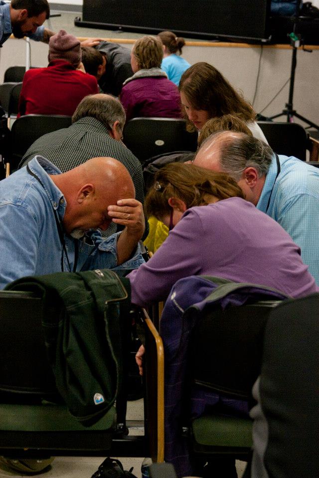 praying at the conference